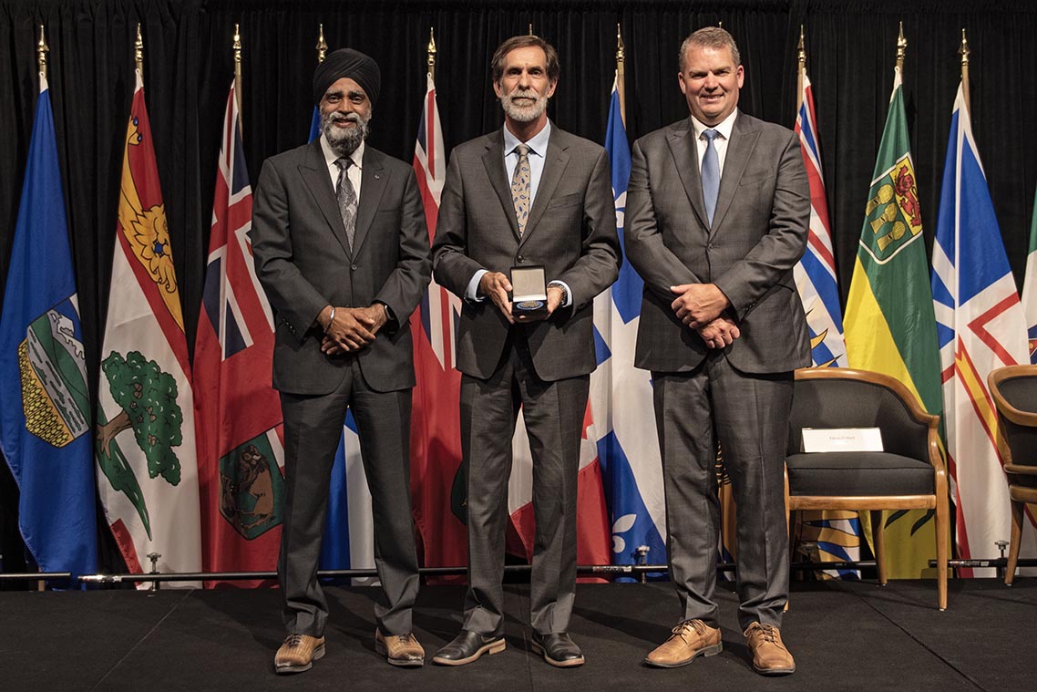 The Honourable Harjit S. Sajjan, President of the King’s Privy Council for Canada and Minister of  Emergency Preparedness (far left) and Minister responsible for the Pacific Economic  Development Agency of Canada, and the Honourable Bloyce Thompson, Deputy  Premier, Minister of Justice and Public Safety and Attorney General for Prince  Edward Island (far right) are pictured with the 2022 award recipient of the  Emergency Management Exemplary Service Award for the Outstanding Contribution  to Emergency Management category.