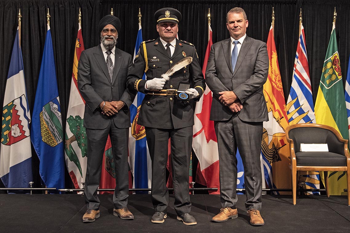 The Honourable Harjit S. Sajjan, President of the King’s Privy Council for Canada and Minister of Emergency  Preparedness (far left) and Minister responsible for the Pacific Economic  Development Agency of Canada, and the Honourable Bloyce Thompson, Deputy  Premier, Minister of Justice and Public Safety and Attorney General for Prince  Edward Island (far right) are pictured with the 2022 award recipient of the  Emergency Management Exemplary Service Award for the Outstanding Contribution  to Emergency Management category.