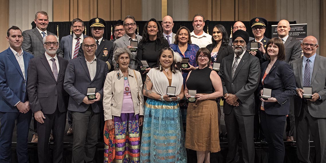 The Honourable Harjit S. Sajjan, President of the King’s Privy Council for Canada and Minister of  Emergency Preparedness and Minister responsible for the Pacific Economic  Development Agency of Canada, and the Honourable Bloyce Thompson, Deputy  Premier, Minister of Justice and Public Safety and Attorney General for Prince  Edward Island are pictured with the 2022 award recipients of the Emergency  Management Exemplary Service Award for the Resilient Communities category.