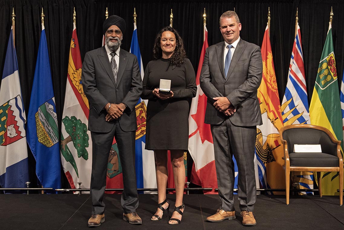 The Honourable Harjit S. Sajjan, President of the King’s Privy Council for Canada and Minister of  Emergency Preparedness (far left) and Minister responsible for the Pacific Economic  Development Agency of Canada, and the Honourable Bloyce Thompson, Deputy  Premier, Minister of Justice and Public Safety and Attorney General for Prince  Edward Island (far right) are pictured with the 2022 award recipient of the  Emergency Management Exemplary Service Award for the Resilient Communities  category.