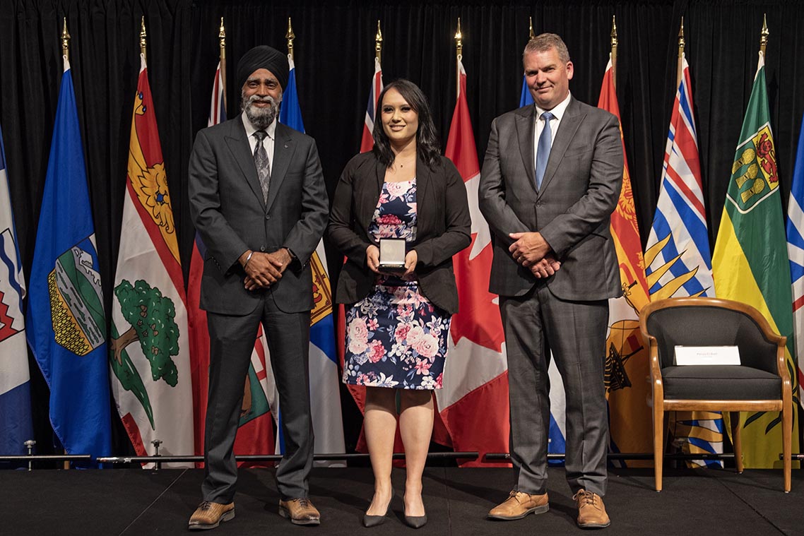 The Honourable Harjit S. Sajjan, President of the King’s Privy Council for Canada and Minister of Emergency  Preparedness (far left) and Minister responsible for the Pacific Economic  Development Agency of Canada, and the Honourable Bloyce Thompson, Deputy  Premier, Minister of Justice and Public Safety and Attorney General for Prince  Edward Island (far right) are pictured with the 2022 award recipient of the  Emergency Management Exemplary Service Award for the Resilient Communities  category.