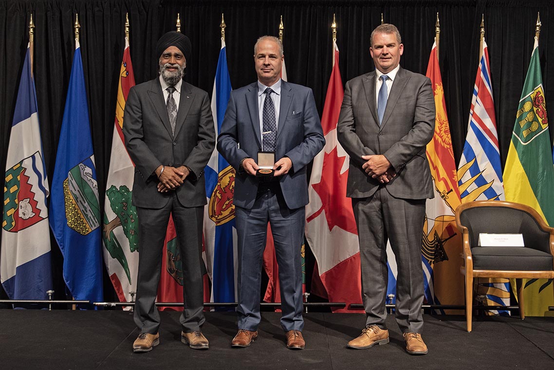 The Honourable Harjit S. Sajjan, President of the King’s Privy Council for Canada and Minister of  Emergency Preparedness (far left) and Minister responsible for the Pacific  Economic Development Agency of Canada, and the Honourable Bloyce Thompson, Deputy  Premier, Minister of Justice and Public Safety and Attorney General for Prince  Edward Island (far right) are pictured with the 2022 award recipient of the  Emergency Management Exemplary Service Award for the Search and Rescue Volunteers  category.