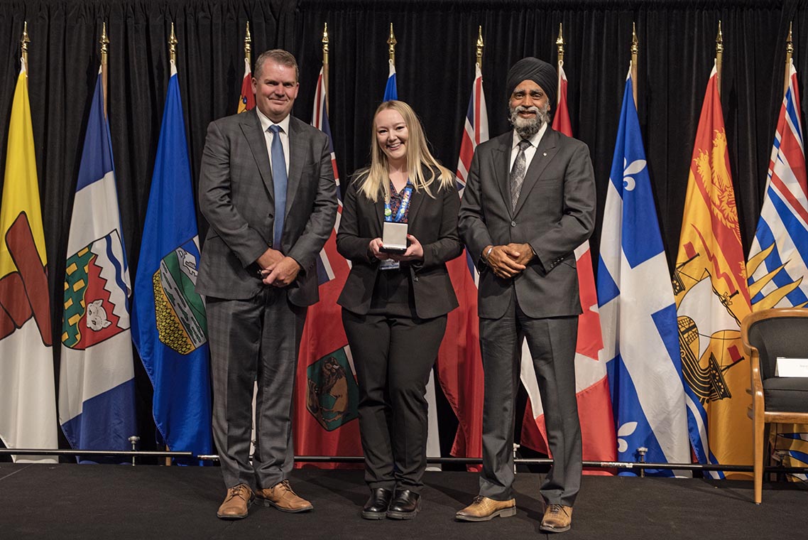 The Honourable Harjit S. Sajjan, President of the King’s Privy Council for Canada and Minister of  Emergency Preparedness (far left) and Minister responsible for the Pacific  Economic Development Agency of Canada, and the Honourable Bloyce Thompson, Deputy  Premier, Minister of Justice and Public Safety and Attorney General for Prince  Edward Island (far right) are pictured with the 2022 award recipient of the  Emergency Management Exemplary Service Award for the Youth category.
