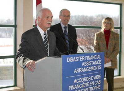 Canada's Public Safety Minister, Vic Toews, accompanied by Manitoba's Infrastructure and Transportation Minister and Minister Responsible for Emergency Measures, Steve Ashton and Brandon's Mayor Shari Decter Hirst, announced $50 million for Manitoba's flood recovery, in Brandon, Manitoba on Monday, November 21, 2011.