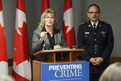 Shelly Glover, Parliamentary Secretary to the Minister of Finance and Member of Parliament for Saint-Boniface, on behalf of the Honourable Vic Toews, Minister of Public Safety, is joined by RCMP D Division Assistant Commissioner, Bill Robinson, after announcing  the launch of the next phase of the Youth Gang Prevention Fund Program, Tuesday, February 21, 2012, in Winnipeg
