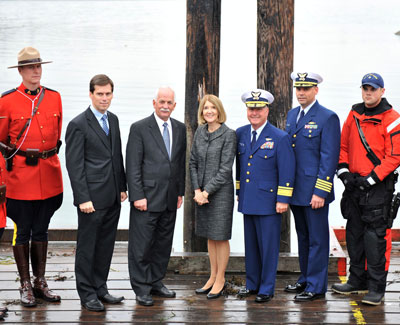 Minister of Public Safety Vic Toews (3rd from left), along with (from left to right) RCMP Constable Michael Della-Paolera, MP Russ Hiebert, U.S. Consul General in Vancouver Anne Callaghan, U.S. Coast Guard Rear Admiral Keith Taylor, U.S. Coast Guard Captain Jose Jimenez, and U.S. Coast Guard Michael Monroe, in White Rock, British Columbia on Friday, October 12, 2012, after announcing that Vancouver/Blaine and Windsor/Detroit will be home to the first two regularized locations of the integrated cross-border maritime law enforcement operations – known as Shiprider.